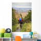 Man Mountain Biking With Dog Running Beside Him Wall Mural