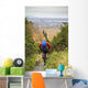 Man Mountain Biking With Dog Running Beside Him Wall Mural