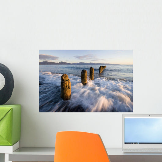 Surf Rushing Around Old Pilings Wall Mural