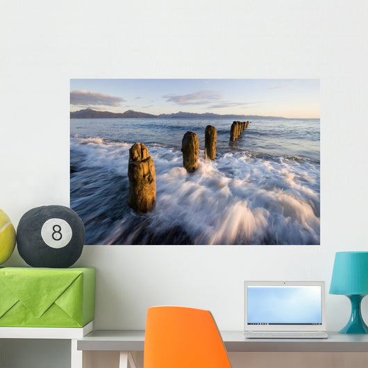 Surf Rushing Around Old Pilings Wall Mural