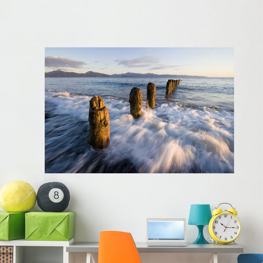 Surf Rushing Around Old Pilings Wall Mural