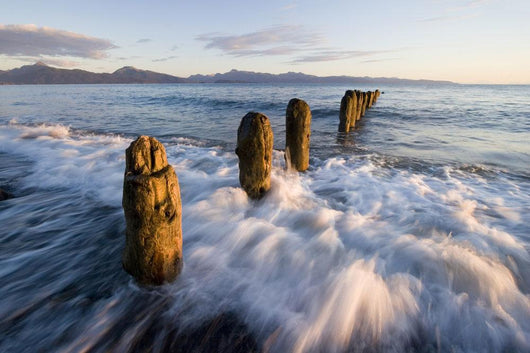 Surf Rushing Around Old Pilings Wall Mural