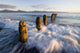 Surf Rushing Around Old Pilings Wall Mural