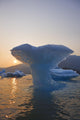 Sunset Beyond Ice Sculpture Of A Whales Tail Wall Mural