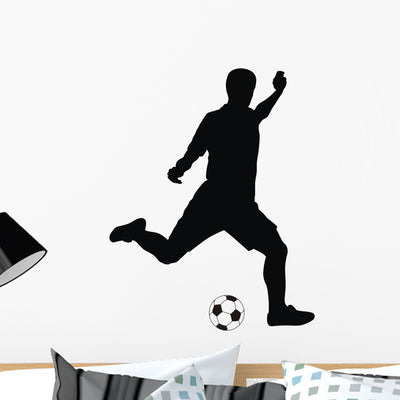 Player Kicking Soccer Wall Decal shown on a wall