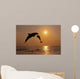 Pair Of Bottle Nose Dolphins Jumping At Sunset Wall Mural