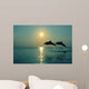 Pair Of Bottle Nose Dolphins Jumping At Sunset Wall Mural