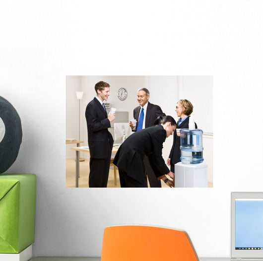 Business people drinking water at water cooler Wall Mural