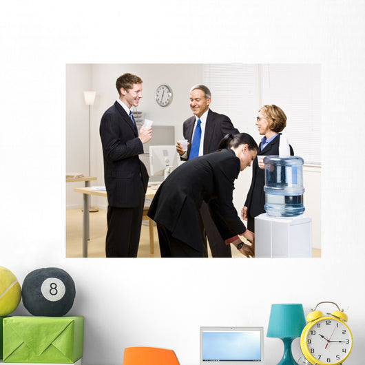 Business people drinking water at water cooler Wall Mural