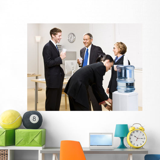Business people drinking water at water cooler Wall Mural