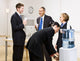 Business people drinking water at water cooler Wall Mural