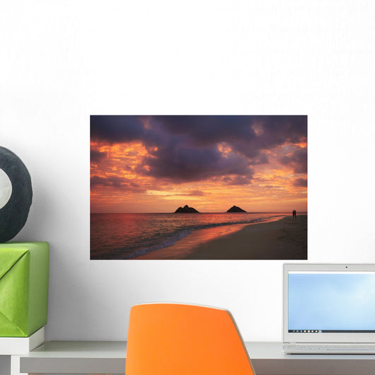 Vibrant sunset with a couple embracing on beach Wall Mural
