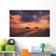 Vibrant sunset with a couple embracing on beach Wall Mural