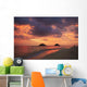 Vibrant sunset with a couple embracing on beach Wall Mural