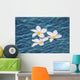 Plumeria flowers floating in clear blue water Wall Mural