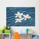 Plumeria flowers floating in clear blue water Wall Mural