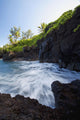 The rocky coastline of Waianapanapa showing the movement of the water Wall Mural