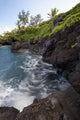 The rocky coastline of Waianapanapa showing the movement of the water Wall Mural