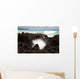 A burst of water through a blowhole in some lava rocks Wall Mural