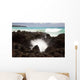 A burst of water through a blowhole in some lava rocks Wall Mural