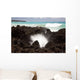 A burst of water through a blowhole in some lava rocks Wall Mural