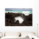 A burst of water through a blowhole in some lava rocks Wall Mural