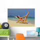 Beautiful woman stretches in a lounge chair on the beach Wall Mural