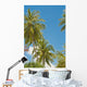 Thailand, Phuket, Vibrant palm trees and clear blue sky Wall Mural