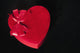 Valentines heart-shaped candy box against black background Wall Mural