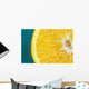 Studio shot of an orange half on a blue background Wall Mural
