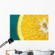 Studio shot of an orange half on a blue background Wall Mural