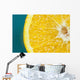 Studio shot of an orange half on a blue background Wall Mural