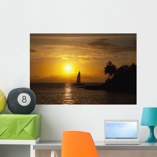 Hawaii, Maui, Makena, A silhouette of a sailboat at sunset Wall Mural