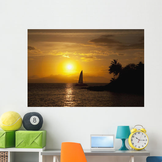 Hawaii, Maui, Makena, A silhouette of a sailboat at sunset Wall Mural