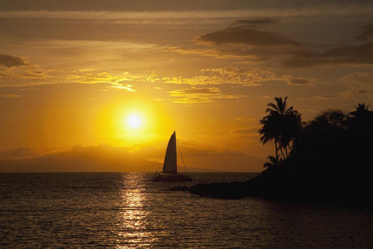 Hawaii, Maui, Makena, A silhouette of a sailboat at sunset Wall Mural