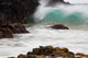 Hawaii, Maui, Makena, An ocean wave crashes among a lava coast Wall Mural