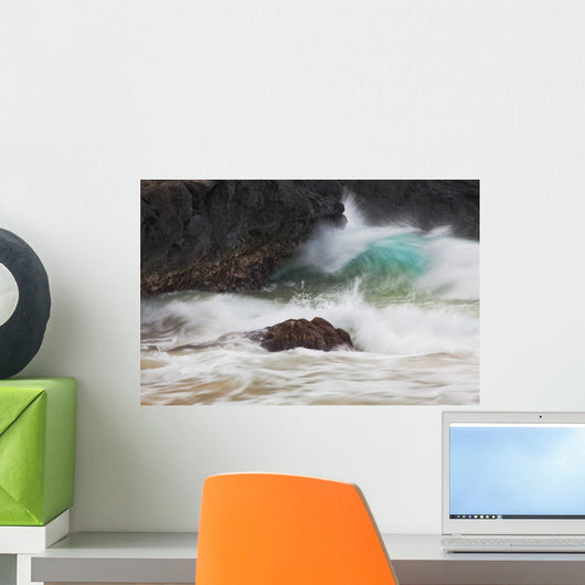 Hawaii, Maui, Makena, An ocean wave crashes among a lava coast Wall Mural