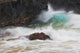 Hawaii, Maui, Makena, An ocean wave crashes among a lava coast Wall Mural