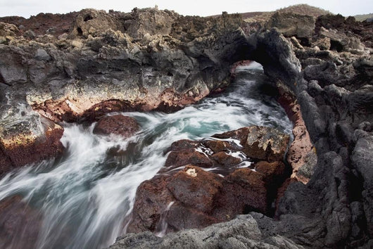 Hawaii, Maui, Makena, Ocean water moving through a lava tube Wall Mural