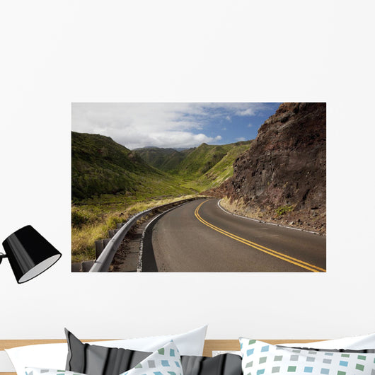 A winding road through Maui's west side with lush mountains Wall Mural