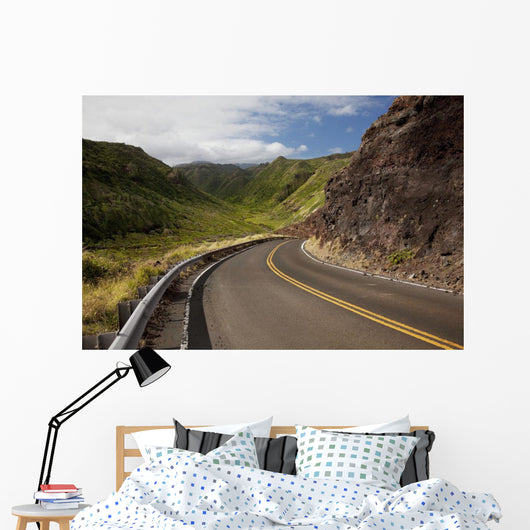 A winding road through Maui's west side with lush mountains Wall Mural
