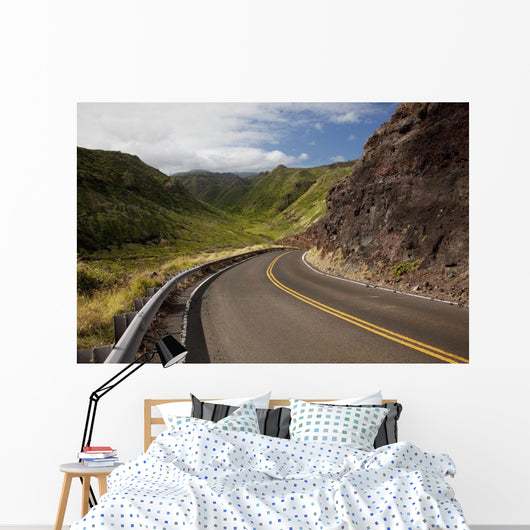 A winding road through Maui's west side with lush mountains Wall Mural