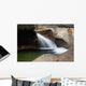A forest riverbed and waterfall Wall Mural