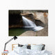 A forest riverbed and waterfall Wall Mural