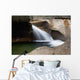 A forest riverbed and waterfall Wall Mural