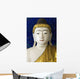 Head of a Buddha statue against blue background Wall Mural