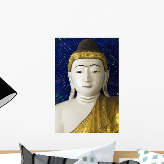 Head of a Buddha statue against blue background Wall Mural