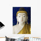 Head of a Buddha statue against blue background Wall Mural
