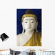 Head of a Buddha statue against blue background Wall Mural