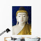Head of a Buddha statue against blue background Wall Mural
